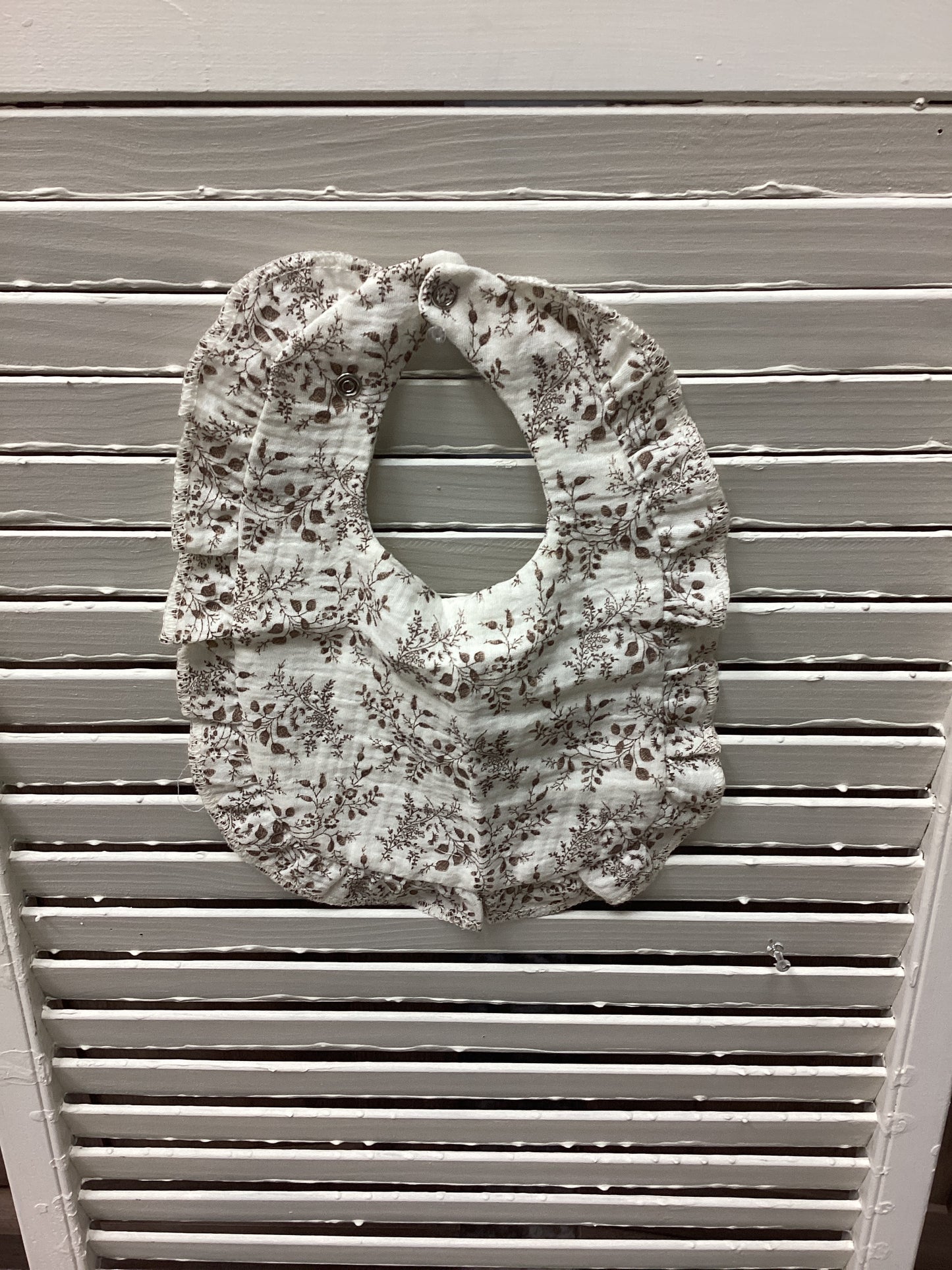 Tan and brown vine bib